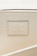 A close-up of the strap's clasps and their gold-color hardware.