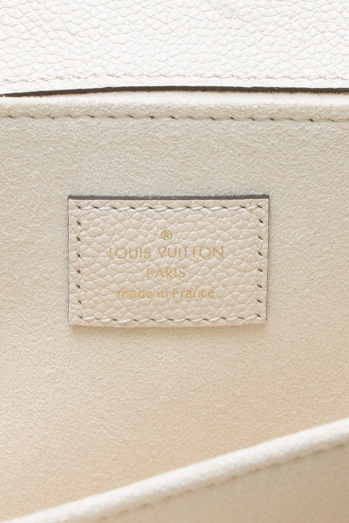 A close-up of the strap's clasps and their gold-color hardware.