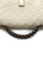The bag shown with its braided top handle.