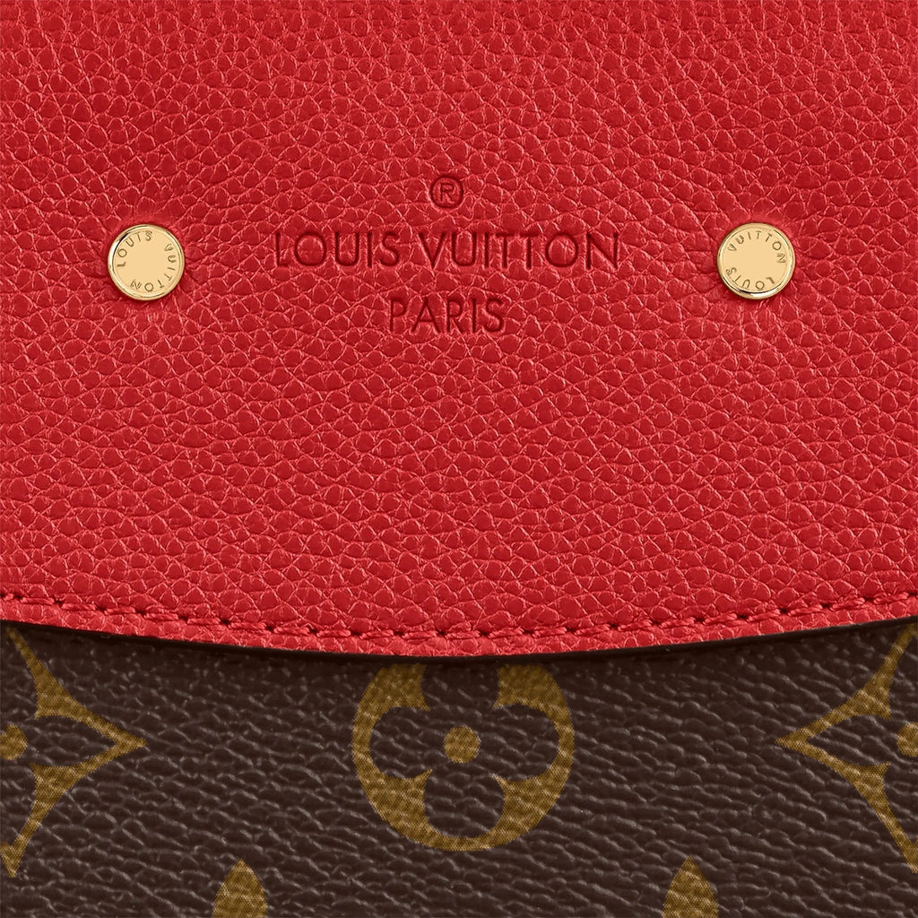 A shot of the golden clasp against the Cerise Red leather