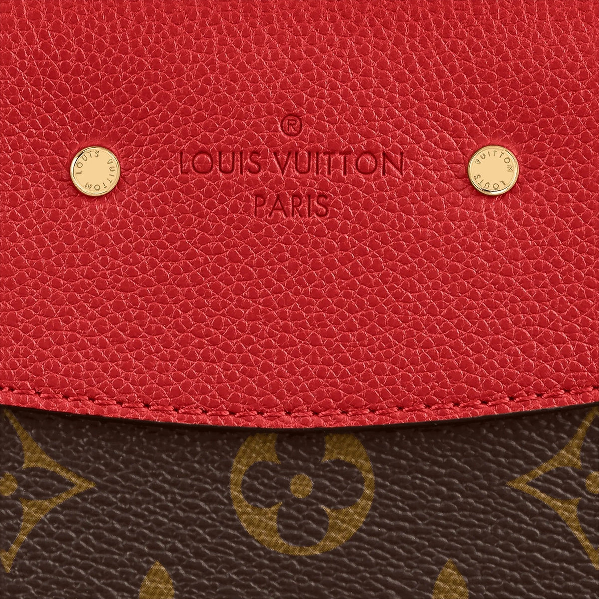 A shot of the golden clasp against the Cerise Red leather